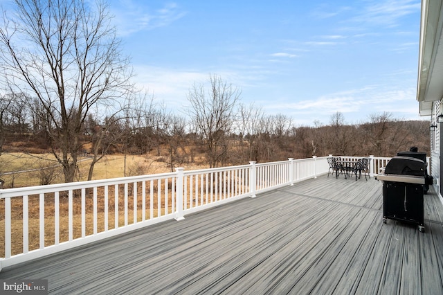 wooden terrace with a grill