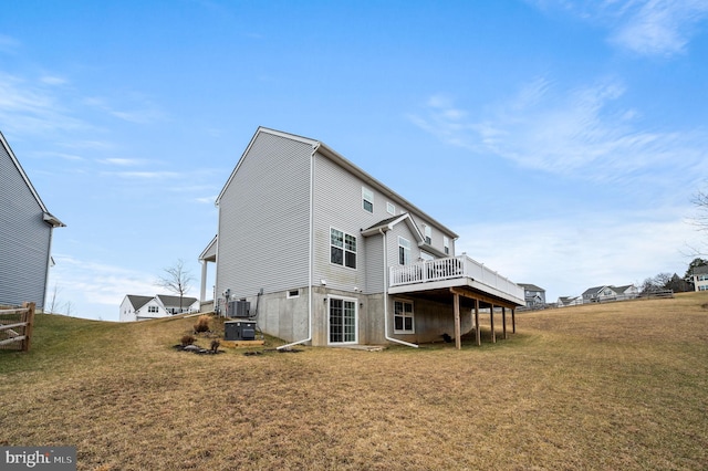 back of property featuring a wooden deck, a lawn, and cooling unit