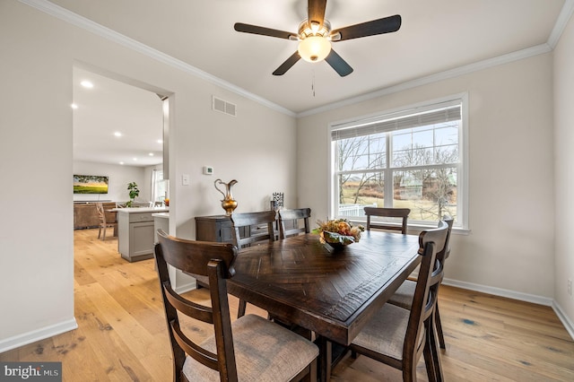 dining area with ornamental molding, light hardwood / wood-style floors, and ceiling fan