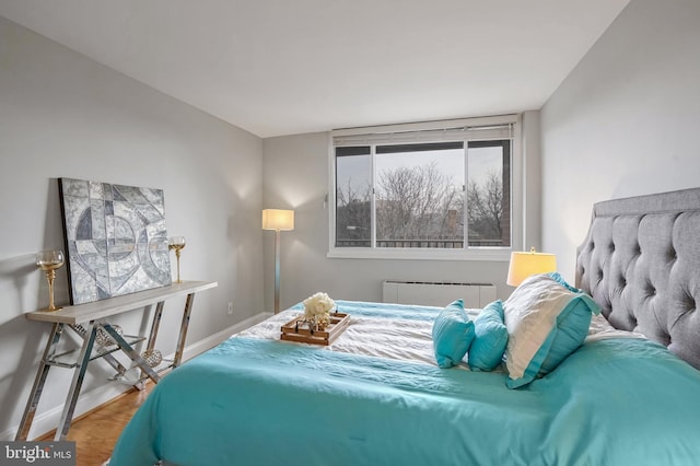 bedroom with hardwood / wood-style flooring