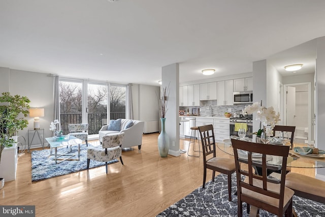 dining space with light wood-type flooring