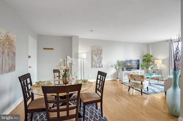 dining space with light hardwood / wood-style flooring