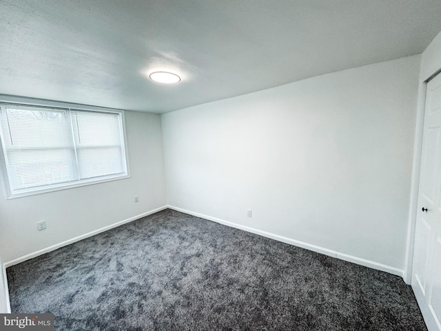 empty room with dark carpet