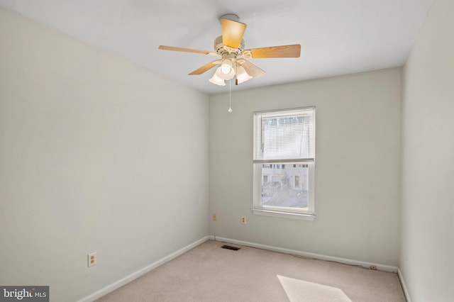 carpeted empty room featuring ceiling fan