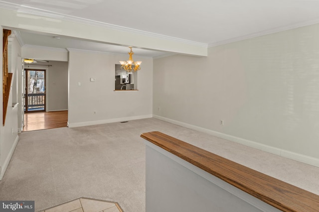 empty room with ornamental molding, ceiling fan with notable chandelier, and light carpet