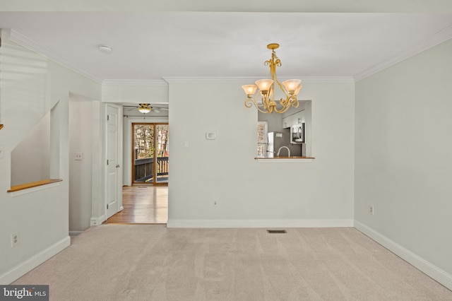 carpeted spare room with crown molding and ceiling fan with notable chandelier