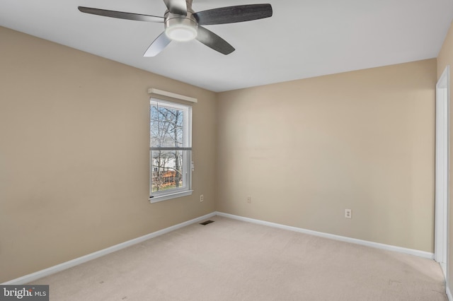 unfurnished room featuring light colored carpet and ceiling fan