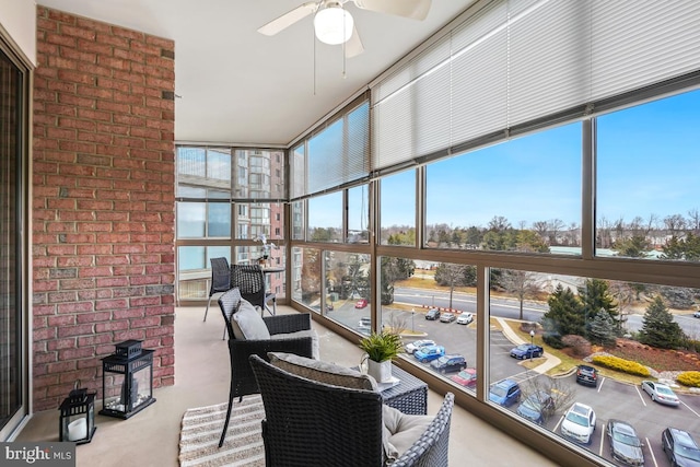 sunroom / solarium featuring ceiling fan