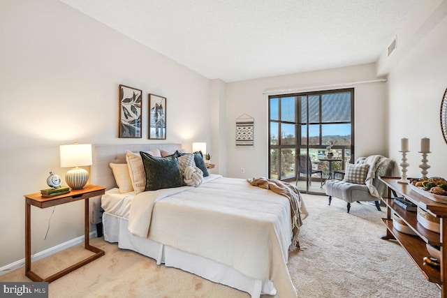 bedroom featuring light carpet, baseboards, visible vents, and a textured ceiling