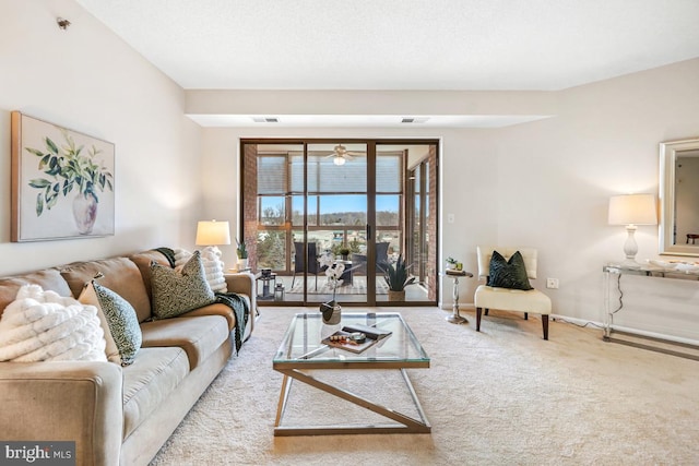 carpeted living room with visible vents and baseboards