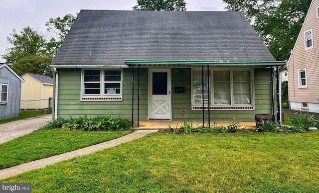 bungalow-style house with a front lawn