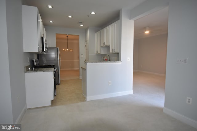 kitchen with recessed lighting, stainless steel microwave, baseboards, and white cabinetry