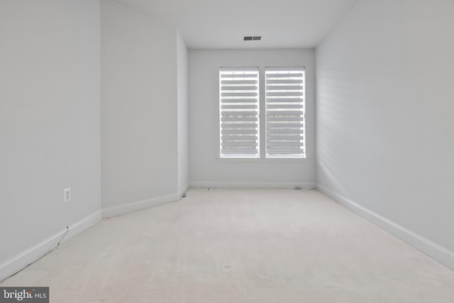 unfurnished room featuring carpet flooring, baseboards, and visible vents