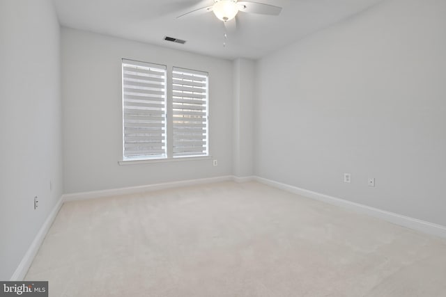 unfurnished room with a ceiling fan, visible vents, baseboards, and carpet floors