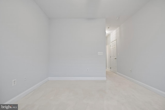 unfurnished room with baseboards