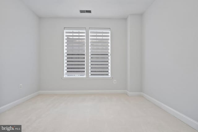 unfurnished room with visible vents, baseboards, and carpet floors