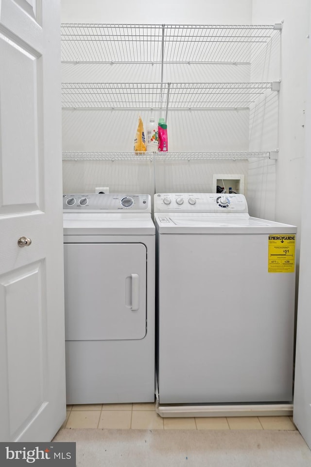 washroom featuring laundry area, light tile patterned floors, and independent washer and dryer