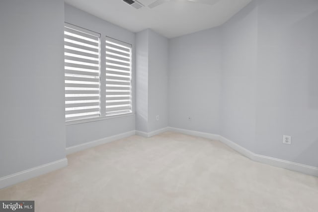 empty room with visible vents, carpet, and baseboards