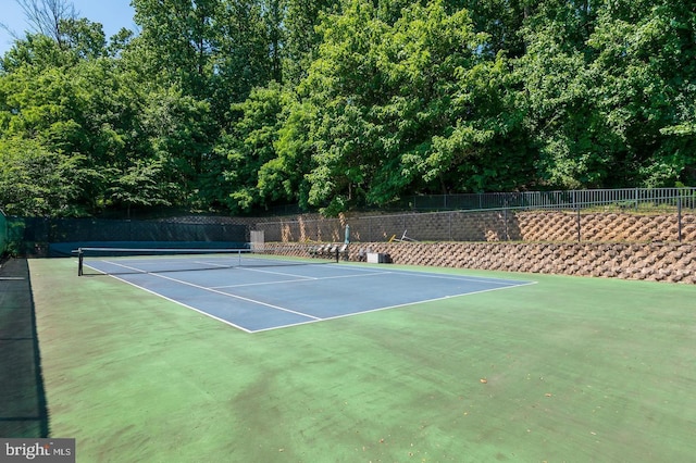 view of sport court featuring fence