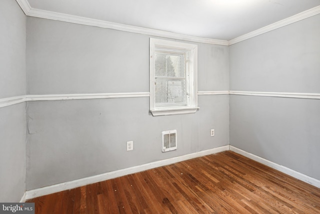 empty room featuring hardwood / wood-style flooring and ornamental molding