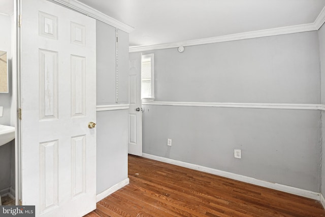 interior space with ornamental molding and dark hardwood / wood-style floors