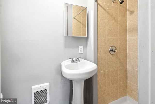 bathroom with sink and tiled shower