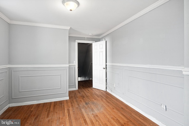 unfurnished room featuring crown molding and wood-type flooring