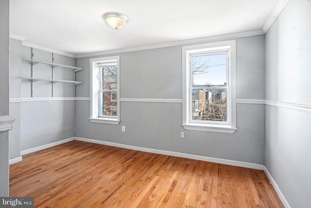 unfurnished room featuring light hardwood / wood-style flooring and ornamental molding