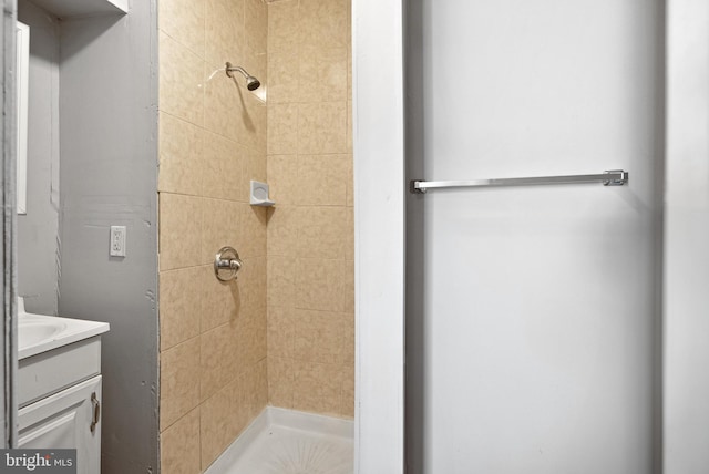 bathroom with vanity and tiled shower