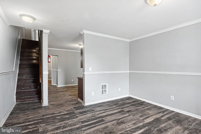 spare room featuring crown molding and dark hardwood / wood-style floors