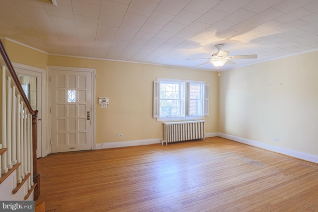 entrance foyer featuring crown molding, radiator heating unit, light hardwood / wood-style floors, and ceiling fan