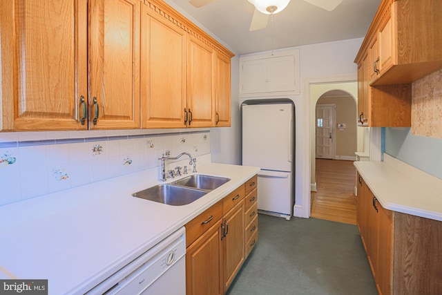 kitchen featuring sink, white appliances, ceiling fan, and backsplash