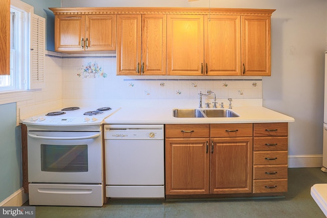 kitchen featuring white appliances, sink, and backsplash