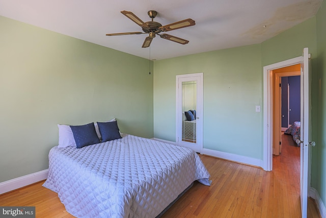 bedroom with ceiling fan and hardwood / wood-style floors