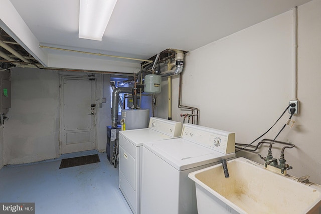 clothes washing area featuring sink and independent washer and dryer