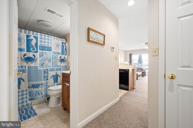 bathroom featuring vanity, toilet, and a shower with shower curtain