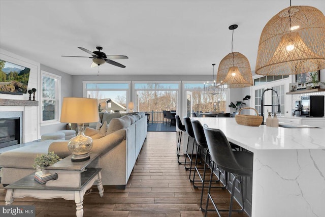 living room featuring sink, dark hardwood / wood-style floors, and ceiling fan