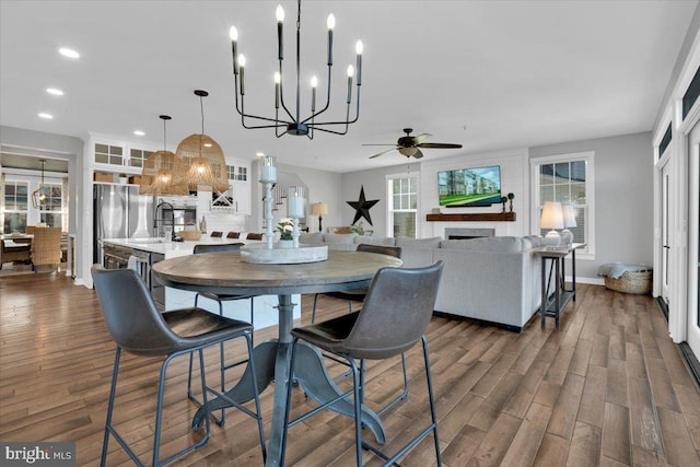 dining space with dark hardwood / wood-style flooring and ceiling fan