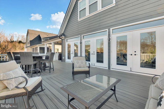 wooden deck featuring french doors and an outdoor bar