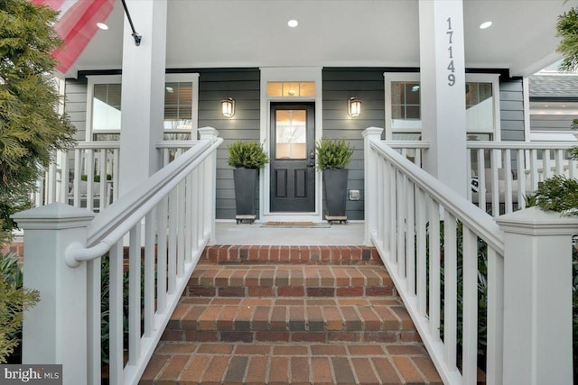 doorway to property featuring covered porch