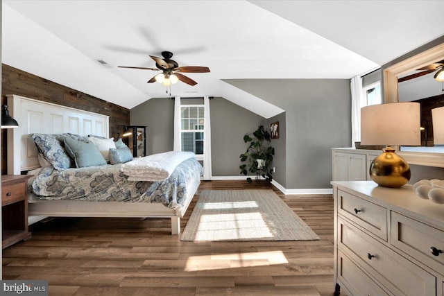 bedroom featuring lofted ceiling and dark hardwood / wood-style flooring