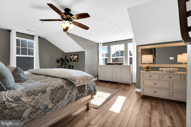 bedroom with lofted ceiling, ceiling fan, and light wood-type flooring