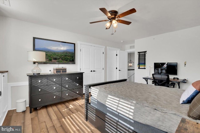 bedroom with ceiling fan and light hardwood / wood-style floors