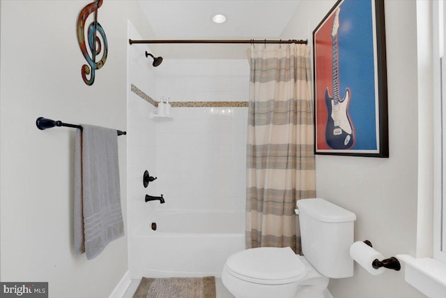 bathroom featuring shower / bath combo and toilet