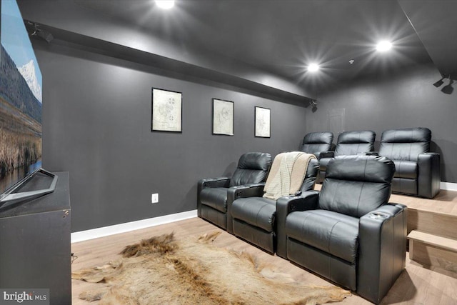 home theater room featuring hardwood / wood-style flooring