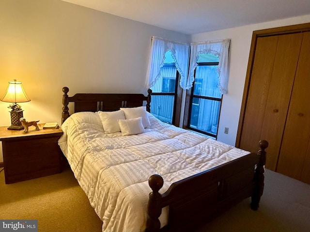 bedroom with light colored carpet and a closet