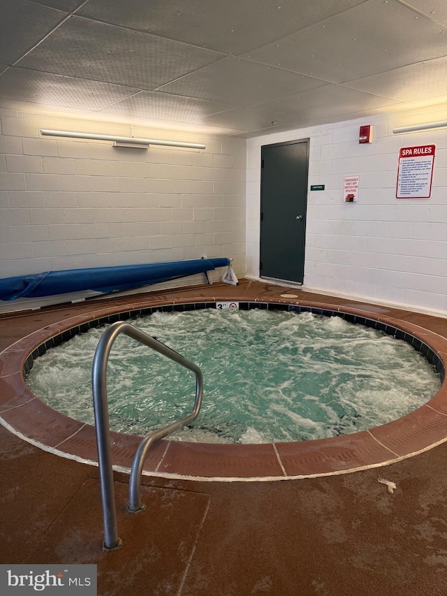 view of swimming pool featuring an indoor in ground hot tub