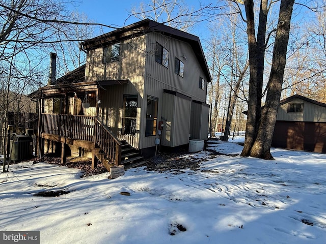 exterior space with a garage and central AC unit