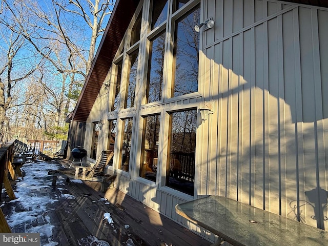 view of snowy exterior featuring a wooden deck