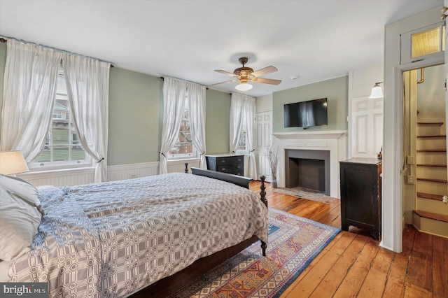 bedroom with hardwood / wood-style flooring and ceiling fan